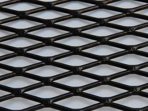 Raised expanded metal steel sheet details with black surface and diamond holes.