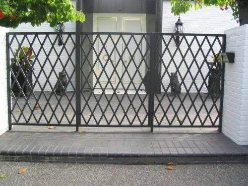 Expanded metal gate made of three expanded metal meshes with black surface and diamond holes in the villa.