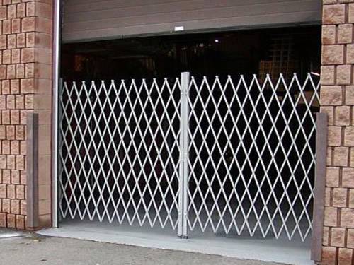 Expanded metal gates with white surface and diamond holes in garage.