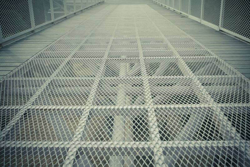 Expanded metal mesh with diamond holes and raised surface is used as flooring.