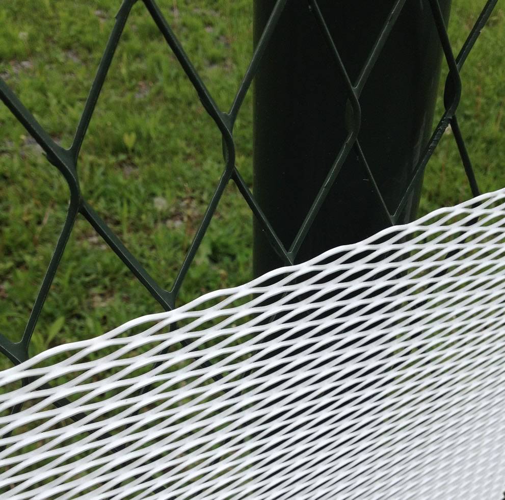 Green reversed diamond orientation expanded fence with larger holes and white standard diamond orientation expanded fence with smaller holes placed on the bottom to prevent snakes going through.