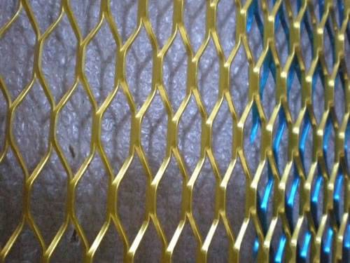Golden raised expanded metal sheet details with hexagonal holes.