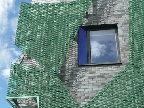 Green aluminum expanded metal meshes with diamond holes are installed on the architectural building facades by trellis.